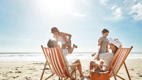 A family on a Tybee Island beach on a late Georgia summer vacation.