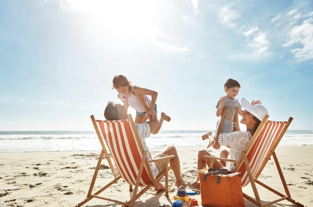 A family on a Tybee Island beach on a late Georgia summer vacation.