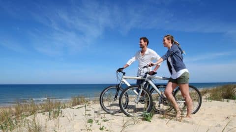 A couple exploring on Tybee Island bike rentals.