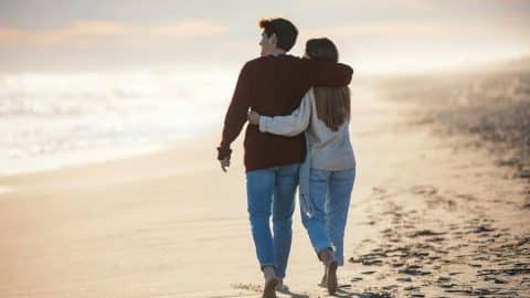 A couple walking on the beach on a winter vacation to Tybee Island, Georgia.