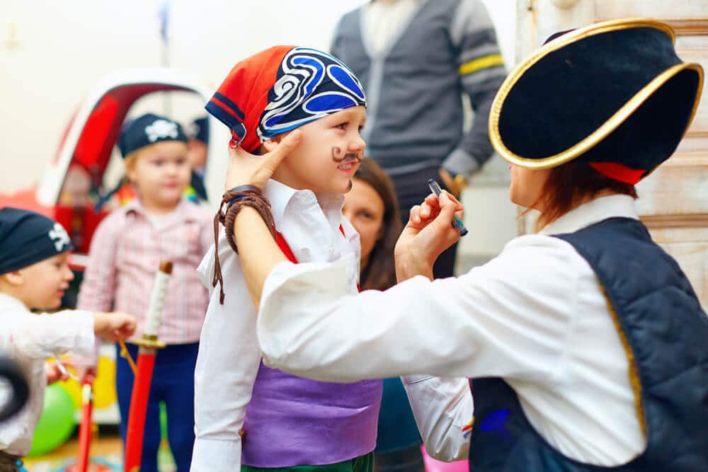 A kid getting face paint at the Tybee Island Pirate Fest.
